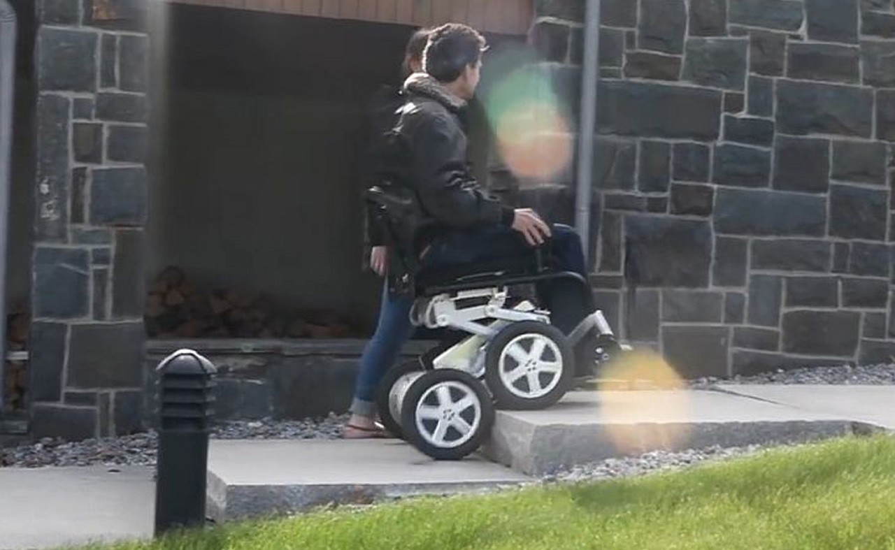 Man demonstrates that the iBOT can climb stairs