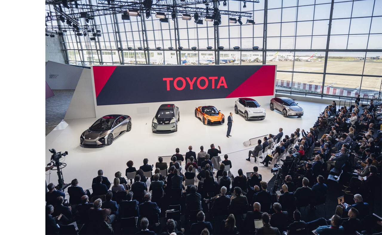 Toyota Kenshiki Forum 2023 live event  with the new electric line up of cars in the background (Toyota FT-Se, Toyota FT-3e, Toyota Sport Crossover concept and the Toyota Urban SUV concept)