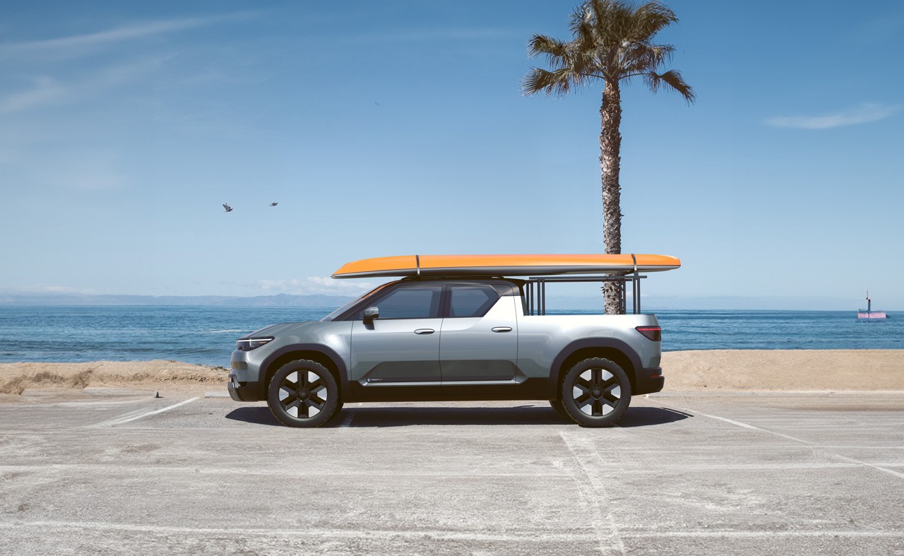 Toyota EPU parked in a beach carpark, with a surfboard on top of it