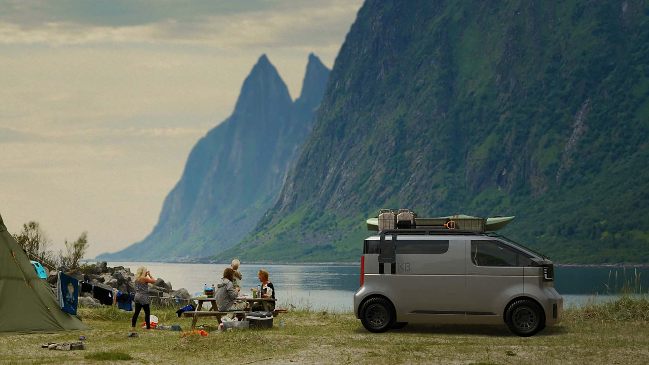 Toyota Kayoikao EV Minivan Concept parked lankside, overlooking a mountain range with a family camping beside it 