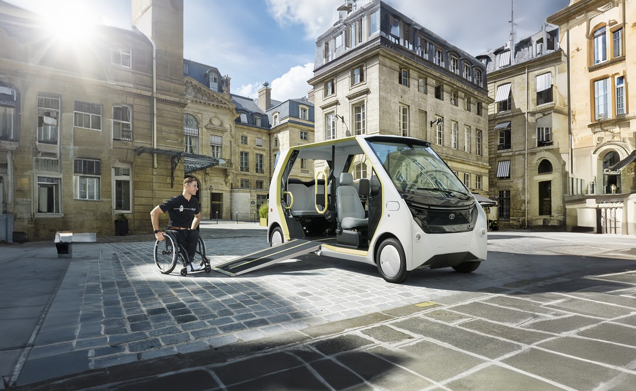 Man in wheelchair, boarding the wheelchair accessible  Toyota APM in Paris