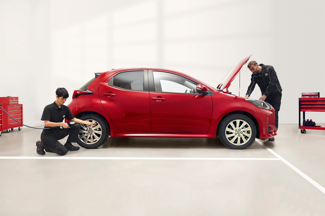 Members of the Toyota maintenance team performing control on a Toyota car